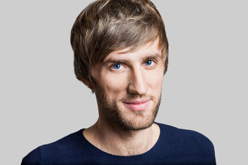 Handsome smiling young man studio portrait