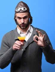 bearded pilot with cocktail in glass