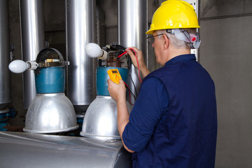 electrician repairing street lamps in a industrial site