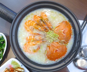 Seafood Porridge with shrimps and crabs closeup 