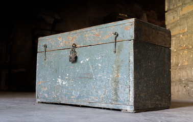 Old wooden toolbox, closed with a padlock, timeworn paint