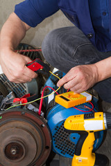 repairman during maintenance work of electric motors