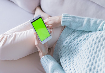 The smartphone in the hands of a young woman