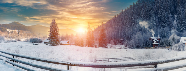 frost, misty sunrise in mountain village. gorgeous winter, morning landscape. christmas concept. artistic creative image