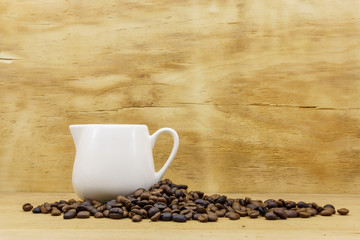 coffee bean and a cup of coffee on wooden background