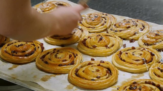 german bakery spread liquid sugar on a pastery roll 4k 11714
