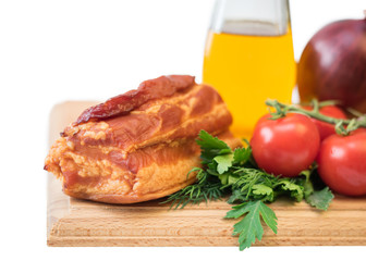 Smoked pork with spices on a wooden board isolated on white background.