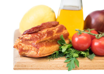 Smoked pork with spices on a wooden board isolated on white background.