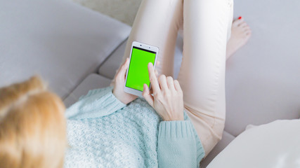 The smartphone in the hands of a young woman