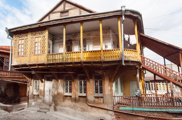 Fototapeta na wymiar Wooden balcony of old mansion in historical area of georgian capital Tbilisi