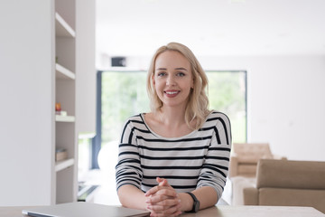 Fototapeta premium Young woman with laptop at home