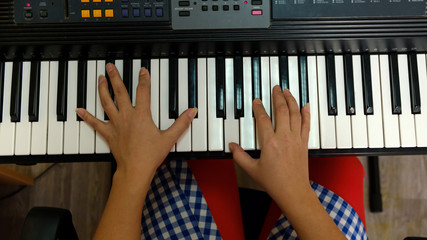 the hands of a musician, plays keyboards.