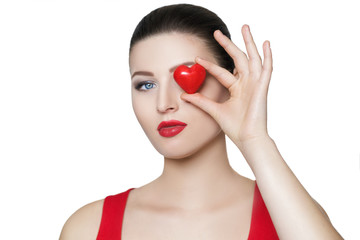 beautiful brunette woman holding red heart in front of the face.