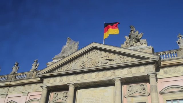 Deutsches Historisches Museum (Zeughaus) in Berlin, Germany. On the roof of the building German flag.