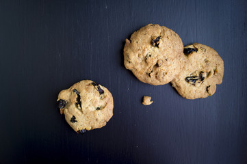 Homemade cookies with raisins on a black background