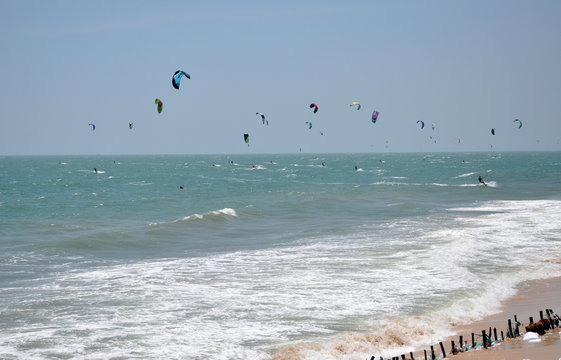 Kite surfers kitesurfing on the sea
