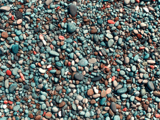 Wet pebbles on the beach.