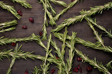 Obraz premium background rosemary, dried cranberries on a wooden table