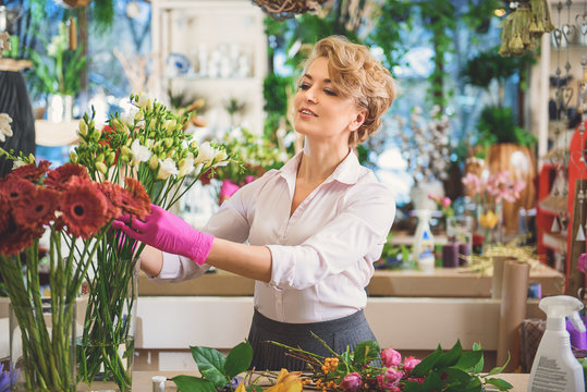 Professional florist making bouquet at store