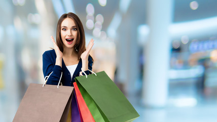 Woman with shopping bags, at shopping centre