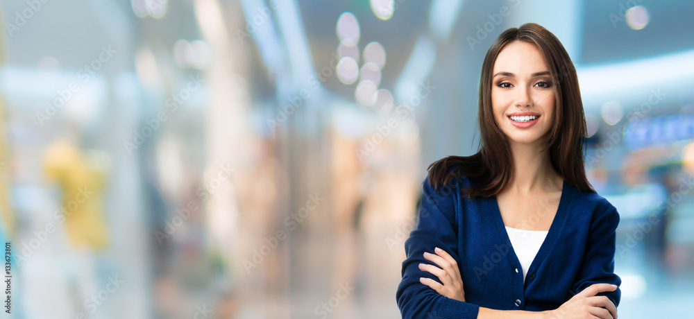 Wall mural woman with crossed arms, at shopping centre