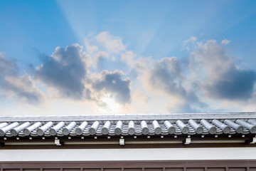 Ancient Traditional Japanese stone wall and old tiled roof from