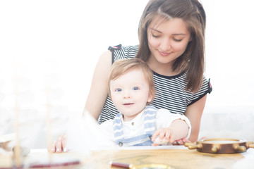 Happy sailor kid and mom playing indoors.