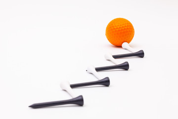 White golf balls and wooden tees