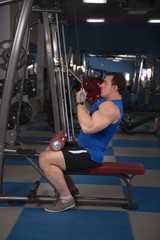 beautiful, powerful, strong man posing at the gym