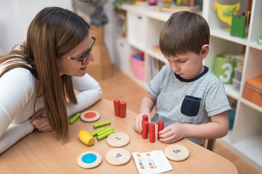 Mother and child are playing with educational toys some learning games
