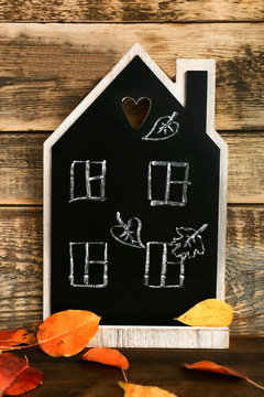 Beautiful autumn composition with chalkboard on wooden background