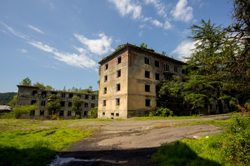 Fototapeta na wymiar Abandoned mining ghost-town Polyana, Abkhazia. Destroyed empty houses 