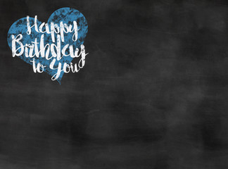 words happy birthday to you written on blackboard with blue heart, copy space
