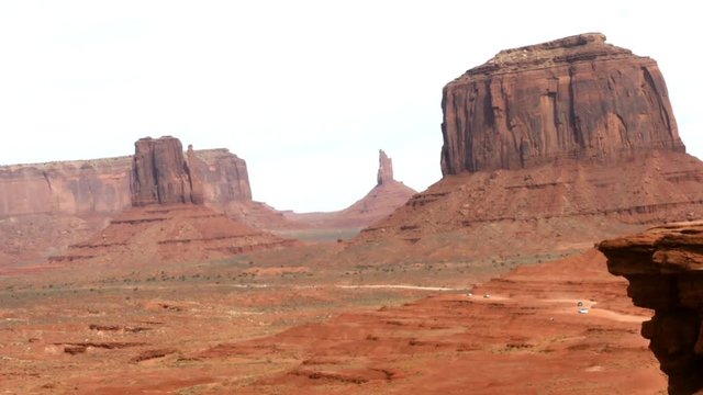 Timelapse of cars, driving on orange sand road and red desert, filmed from john wayne point, in monument valley, in Arizona, United states of America