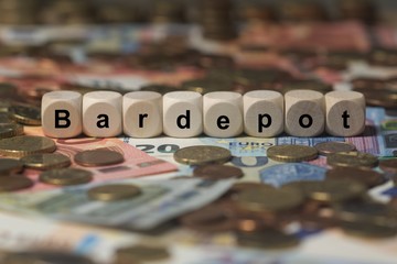bardepot - Holzwürfel mit Buchstaben im Hintergrund mit Geld, Geldscheine