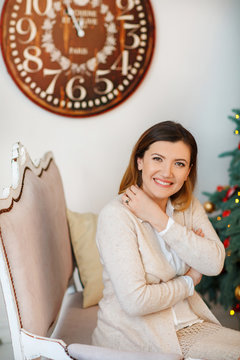 beautiful girl sitting on a couch and smiling