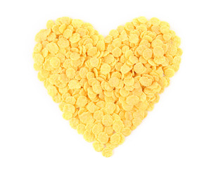 Heart made of cornflakes on white background