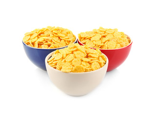 Bowls with cornflakes on white background