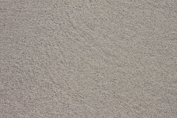 Close-up seamless sand background. Sand texture. Sandy beach for background. Top view. Photos clean, smooth, wet sand closeup. Texture of white sand with a gray tint. Photos sea coast