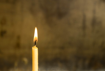 A burning candle in church
