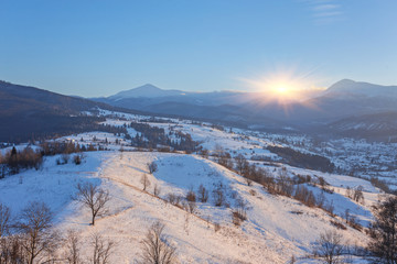 Fototapeta premium Fantastic winter landscape and trodden tourist path leading into the mountains. On the eve of the holiday.