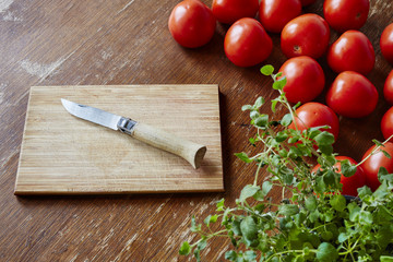 tomatoes and herbs with knife and cuttingboard