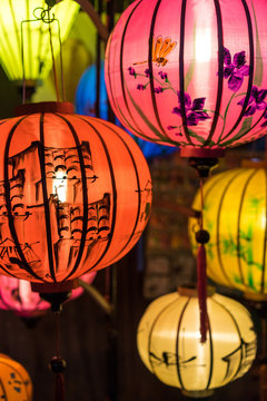 Close view of colorful paper lanterns spread light on the old street of Hoi An Ancient Town - UNESCO World Heritage Site. Vietnam.