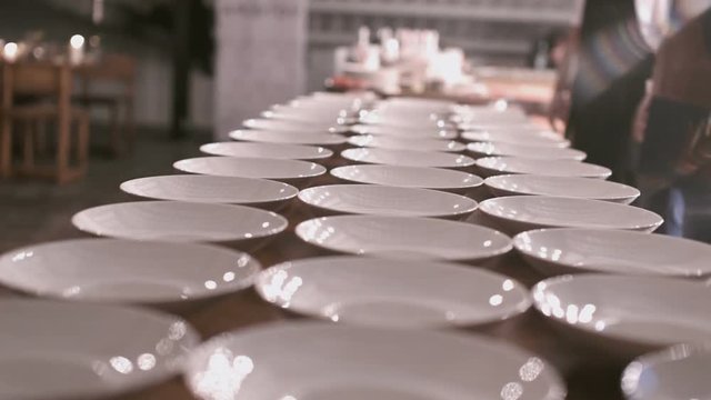 Catering. exquisite serving dinner. a lot of empty white plates