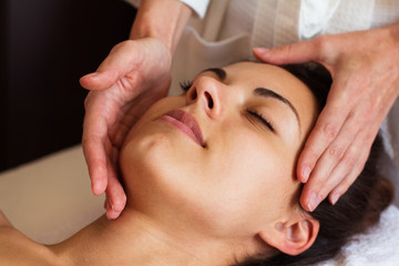 Obraz na płótnie Canvas Face Massage. Close-up of a beautiful Woman Getting Spa Treatmen