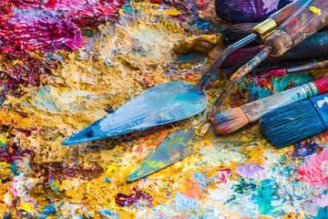 oil paints and paint brushes on a palette
