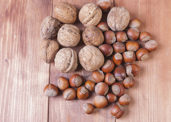 Mix of nuts on wooden background.