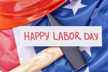 Fototapeta na wymiar Hammer on american flag background. Happy Labor Day congratulation. Actions speak louder than words.
