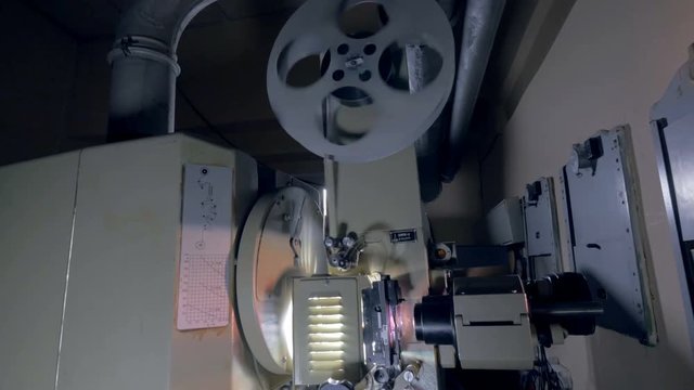 Vintage projector. 8 mm, 35 mm film projector projecting beams of light. 4K.