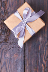 Top view of present box. Wisteria color ribbon bow. Celebration begins with gifts.